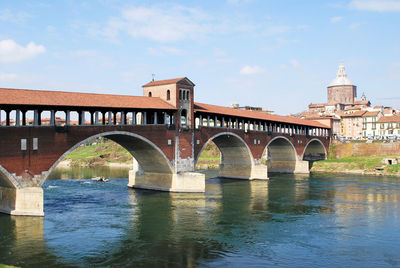 Covered bridge over the ticino river from borgo ticino in pavia, lombardy, italy.