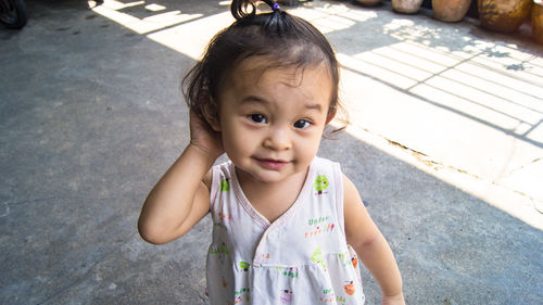 Portrait of cute girl holding baby