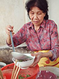 Female vendor selling soup in market
