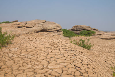 Rock formation on land against clear sky