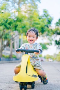 Portrait of cute boy riding motorcycle