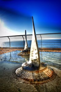 Water on beach against sky