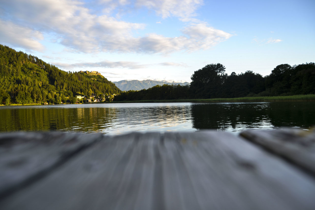 tranquil scene, scenics, tranquility, lake, water, tree, sky, reflection, beauty in nature, mountain, majestic, idyllic, nature, cloud - sky, blue, non-urban scene, vacations, calm, day, tourism, remote, outdoors, countryside, waterfront, no people, surface level, water surface