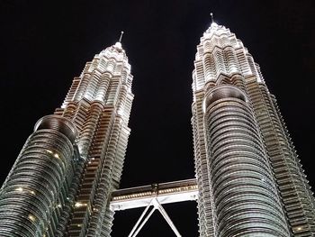 Low angle view of illuminated buildings against sky at night