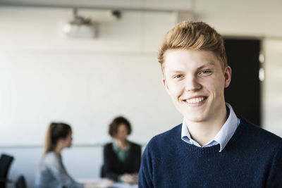 Portrait of happy young man in classroom