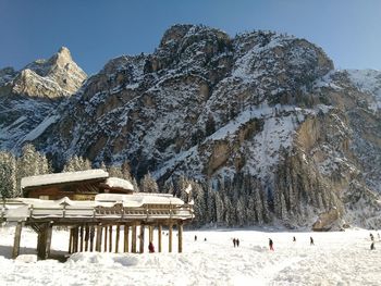 Low angle view of snow covered mountain against clear sky