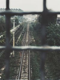 Close-up of railroad tracks against sky during rainy season