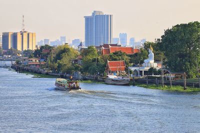View of trees and buildings against clear sky