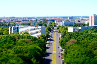 Tilt-shift image of cityscape against sky