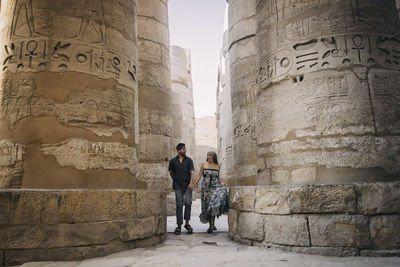 People standing in front of historical building