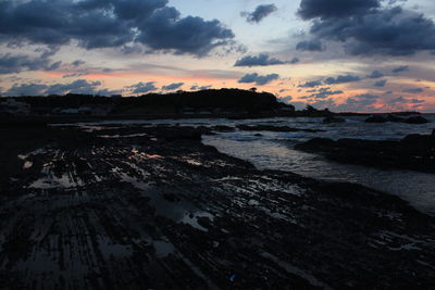 Scenic view of beach against sky during sunset