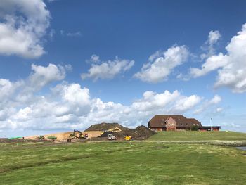 Houses on field against sky