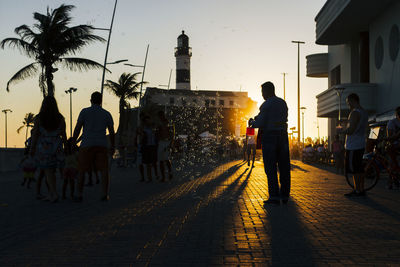 Silhouette of people standing in city