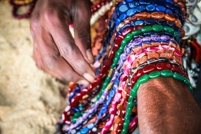 Close-up of man selling jewelry outdoors