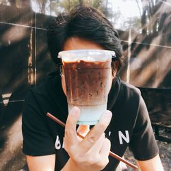 Midsection of man holding ice cream