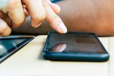 Cropped hands of man using mobile phone