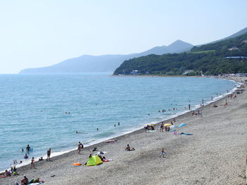 People on beach against sky