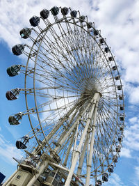 Low angle view of ferris wheel against sky