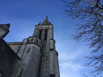 Low angle view of historic church against blue sky