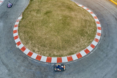 Aerial top view of the go-kart track from the drone. kart racers drive on the open track.