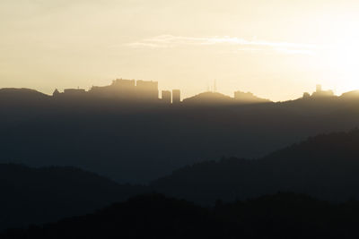 Scenic view of silhouette mountains against sky during sunset