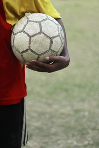 Footballer standing with a ball in hand in kolkata.
