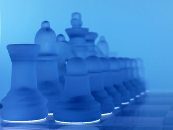 Close-up of glass chess pieces on board