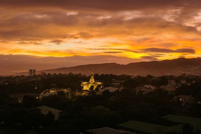 Silhouette buildings against sky during sunset