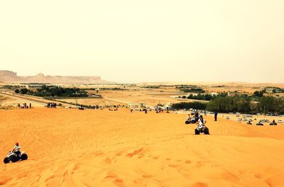 Tourists on sandy beach