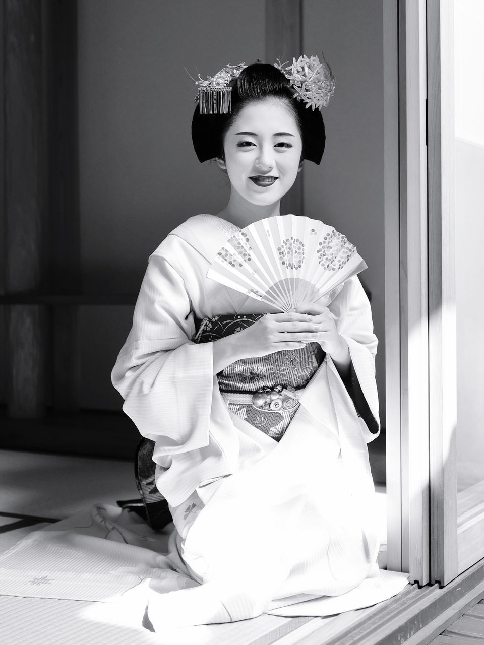 female, women, black and white, one person, adult, culture, portrait, kimono, young adult, clothing, white, monochrome photography, smiling, person, looking at camera, monochrome, fashion, indoors, traditional clothing, happiness, lifestyles, robe, architecture, arts culture and entertainment, bun, emotion, elegance, child, occupation