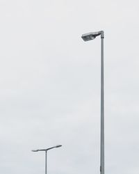 Low angle view of street light against sky