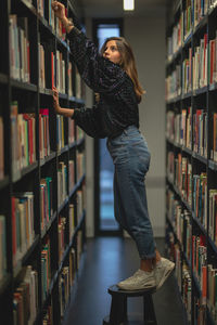 Side view of young woman looking at book
