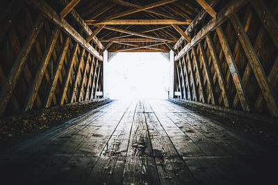 Low angle view of empty tunnel amidst buildings