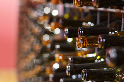 Close-up of wine bottles on rack