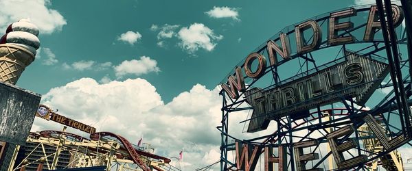 Low angle view of ferris wheel against sky