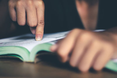 Close-up of hand holding book