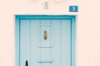 Closed door of blue sign on wall