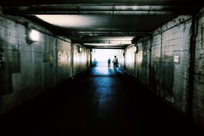 Woman walking in tunnel