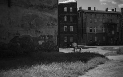 Houses by road against buildings in city