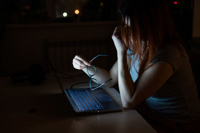 Depressed woman sitting in darkroom