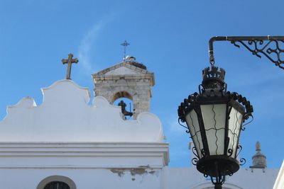 Low angle view of street light against building