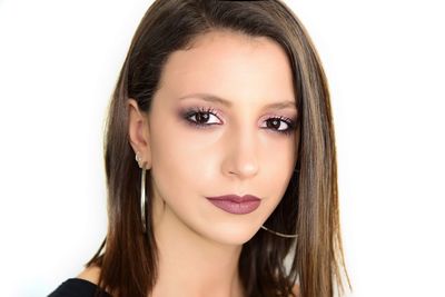 Close-up portrait of a beautiful young woman over white background