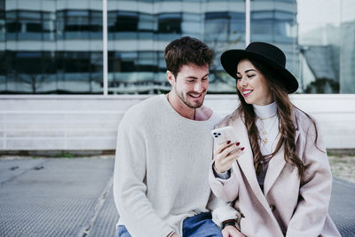 Young man and woman in city