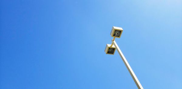 Low angle view of outdoor street  light fixture against clear blue sky