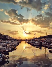 Sailboats in marina at sunset