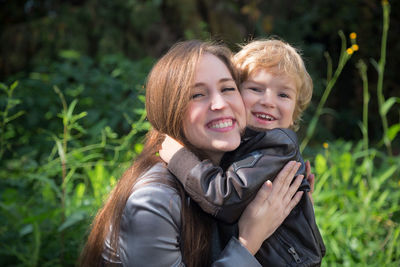 Portrait of smiling woman with son