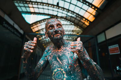Low angle portrait of man standing at home