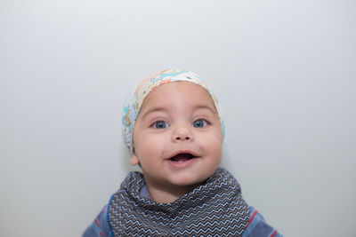 Portrait of cute baby boy against white background