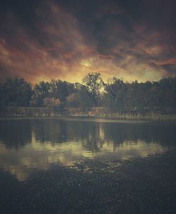 Scenic view of lake against sky at sunset