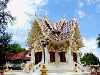 Low angle view of temple against cloudy sky